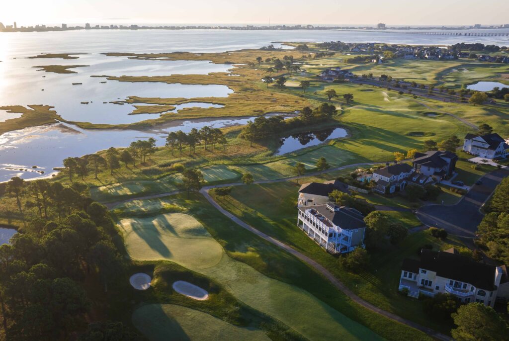 an aerial view of a golf course near the water