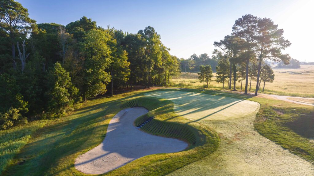 a golf course in the middle of a wooded area