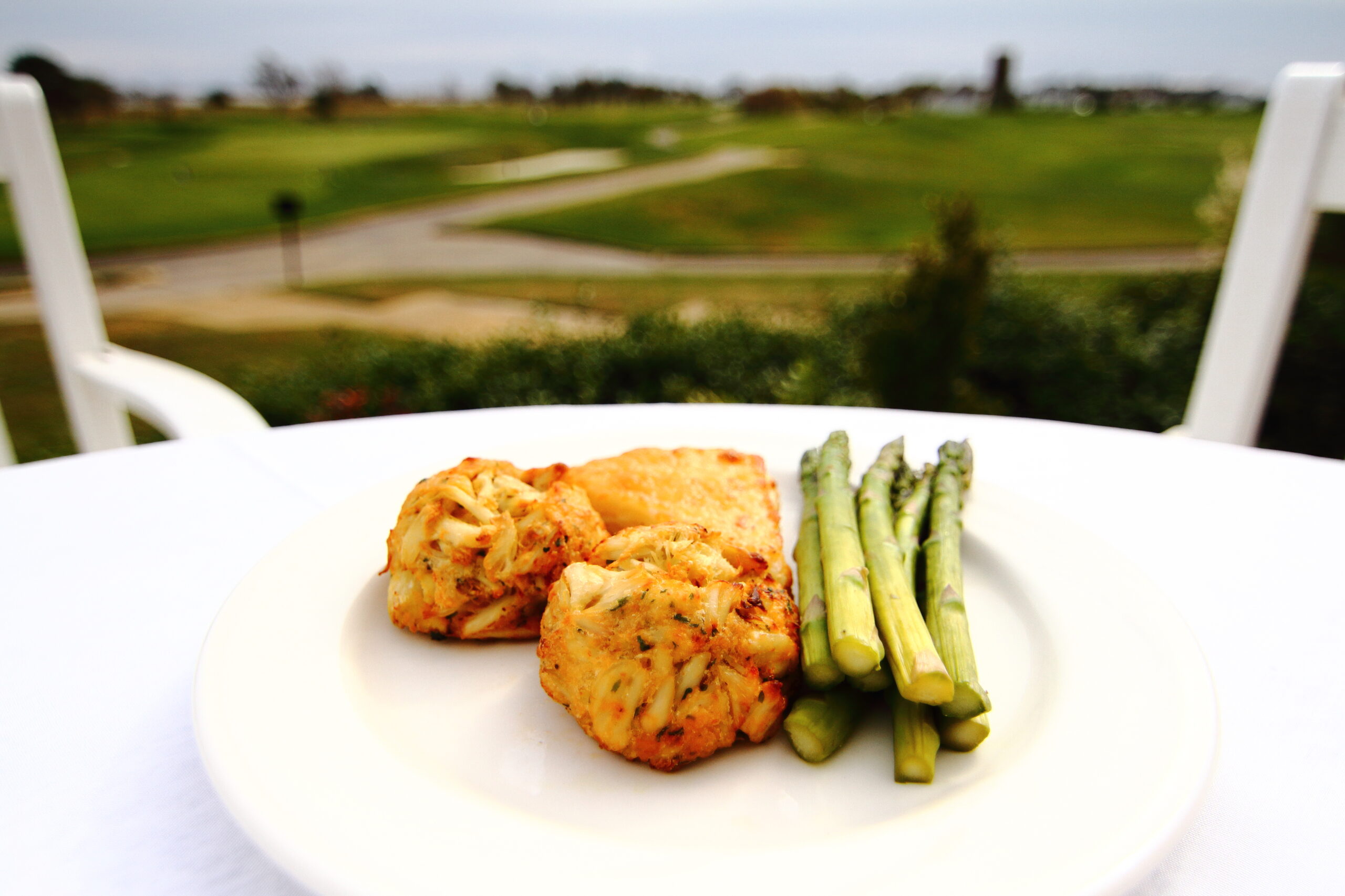 a white plate topped with chicken and asparagus