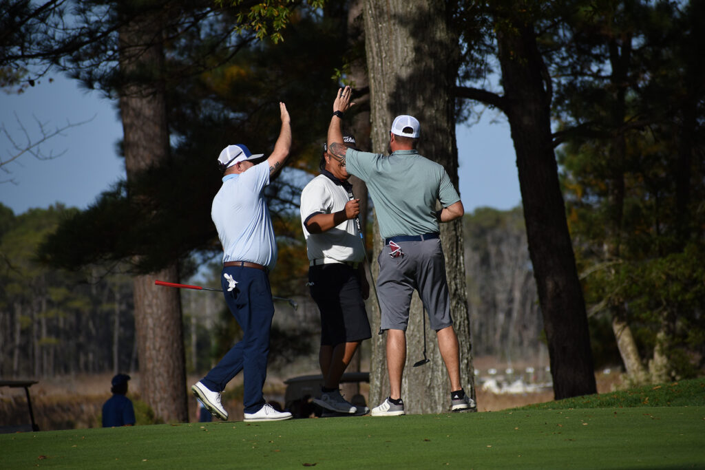 a group of men playing a game of golf