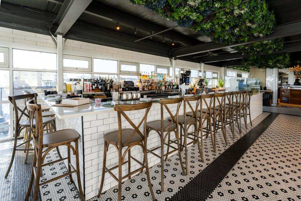 a bar with a bunch of stools next to it