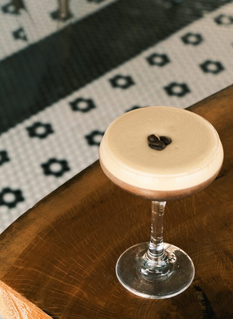 a wooden table with a wine glass on top of it