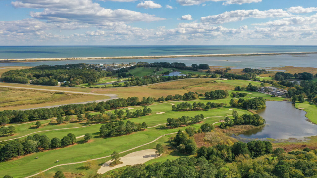 an aerial view of a golf course near the ocean