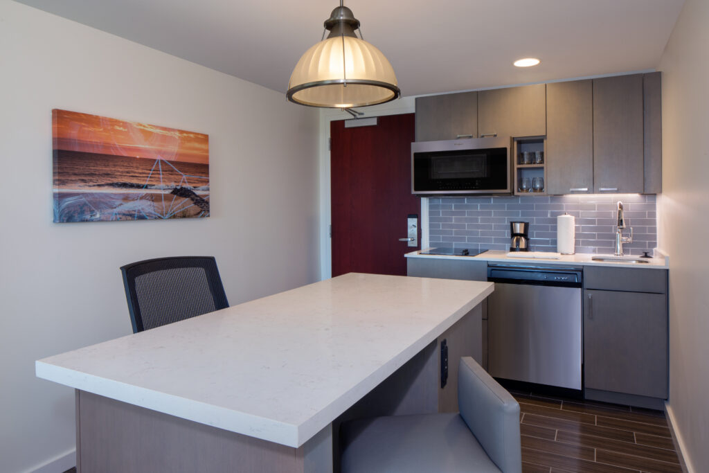 a kitchen with a white counter top next to a refrigerator freezer